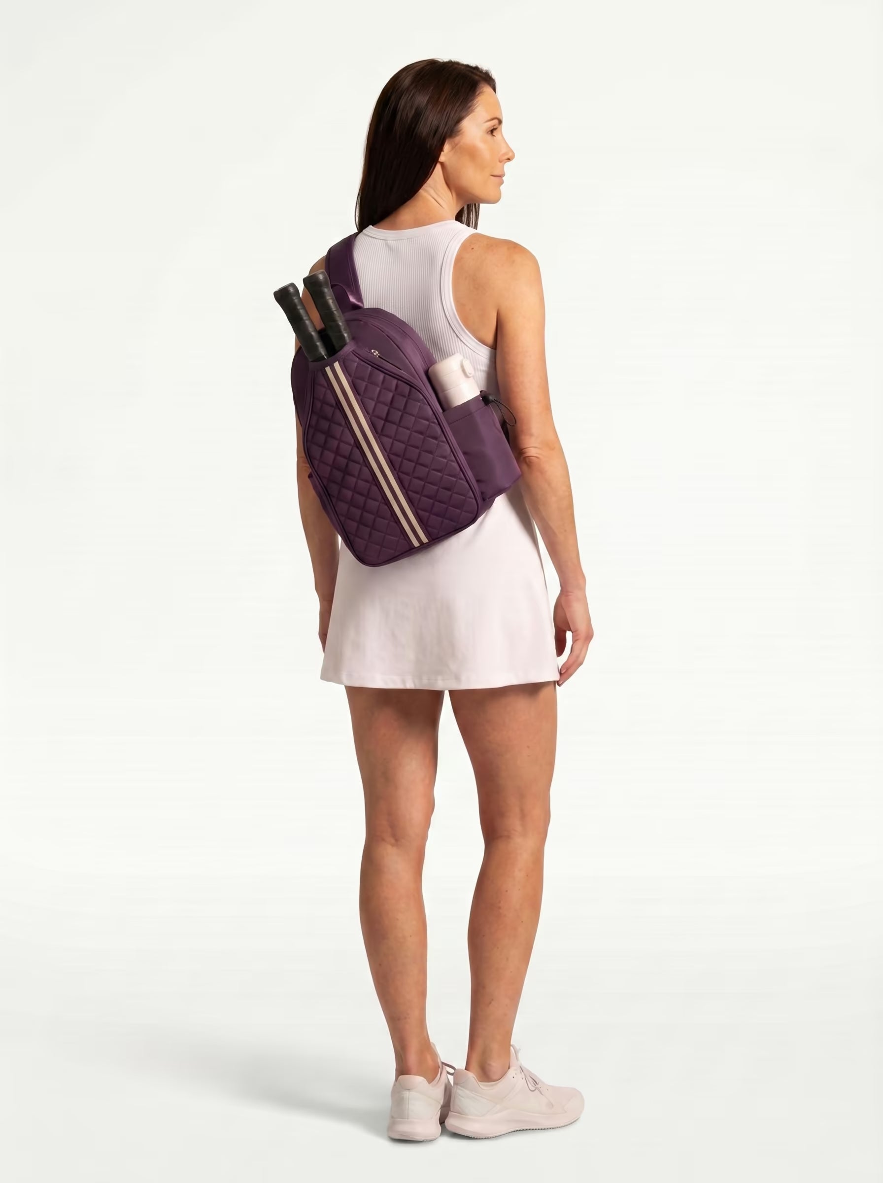 Woman wearing Purple Rally Cross Body Backpack on the way to play pickleball