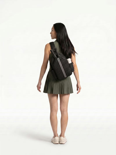 Woman wearing Black Rally Cross Body Backpack on the way to play pickleball