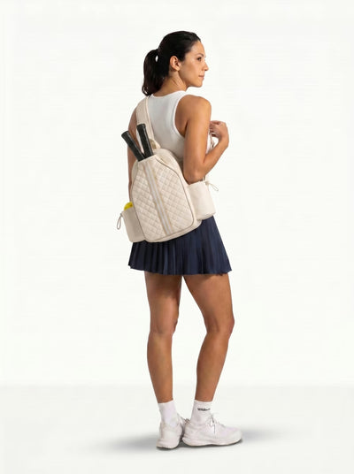 Woman wearing Beige Rally Cross Body Backpack on the way to play pickleball