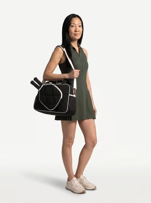 Woman wearing Black Rally All Day Duffle crossbody on the way to play pickleball