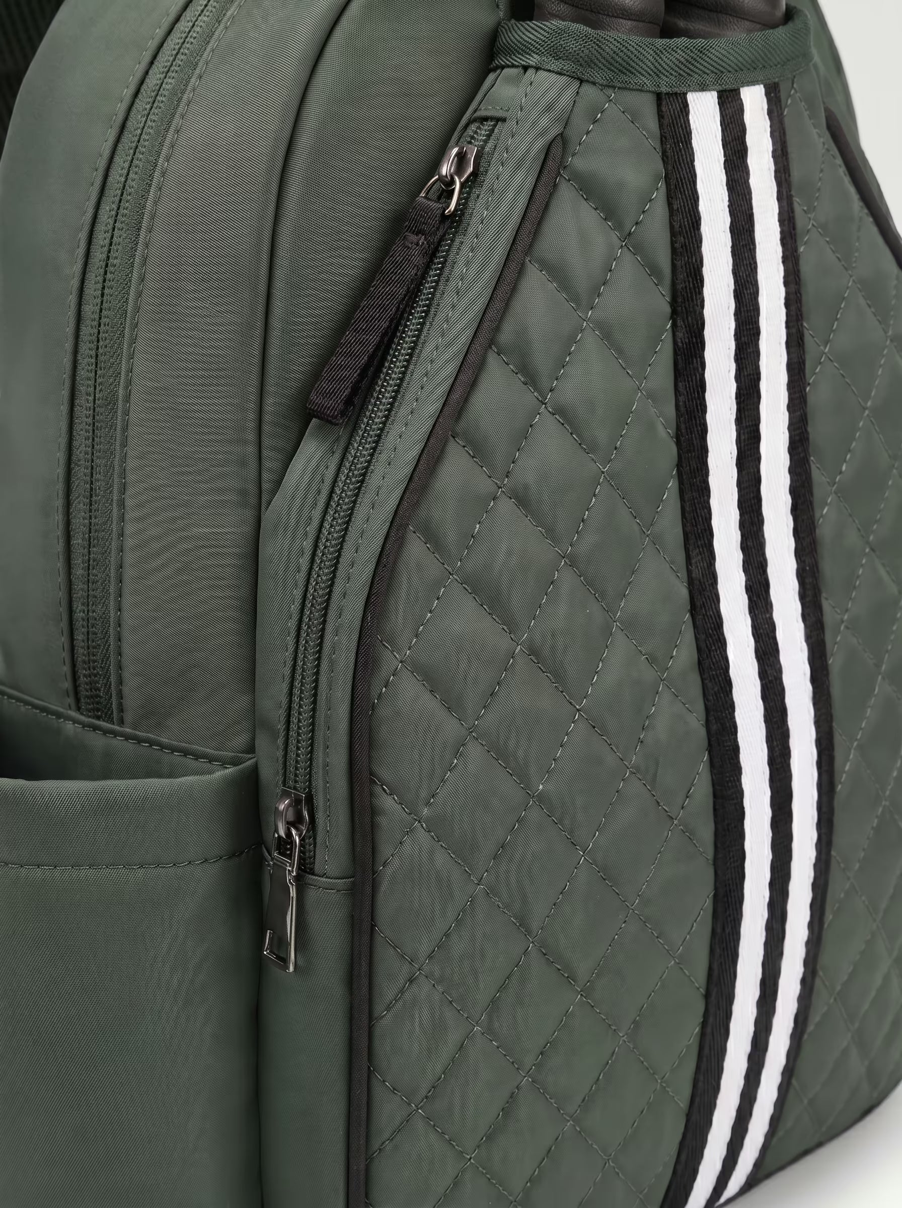 Padded paddle sleeve detail on Rally Cross Body Backpack in Green