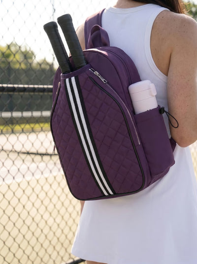 Lifestyle shot of Rally Cross Body Backpack in Purple with pickleball gear