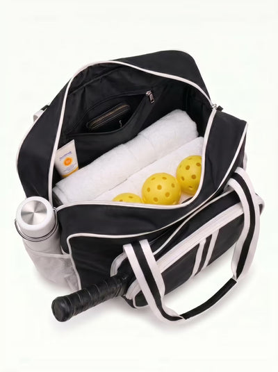 Woman carrying Rally Court Tote in Black on the way to play pickleball