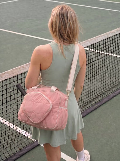 Woman with Rally All Day Duffle in Pink at outdoor pickleball court
